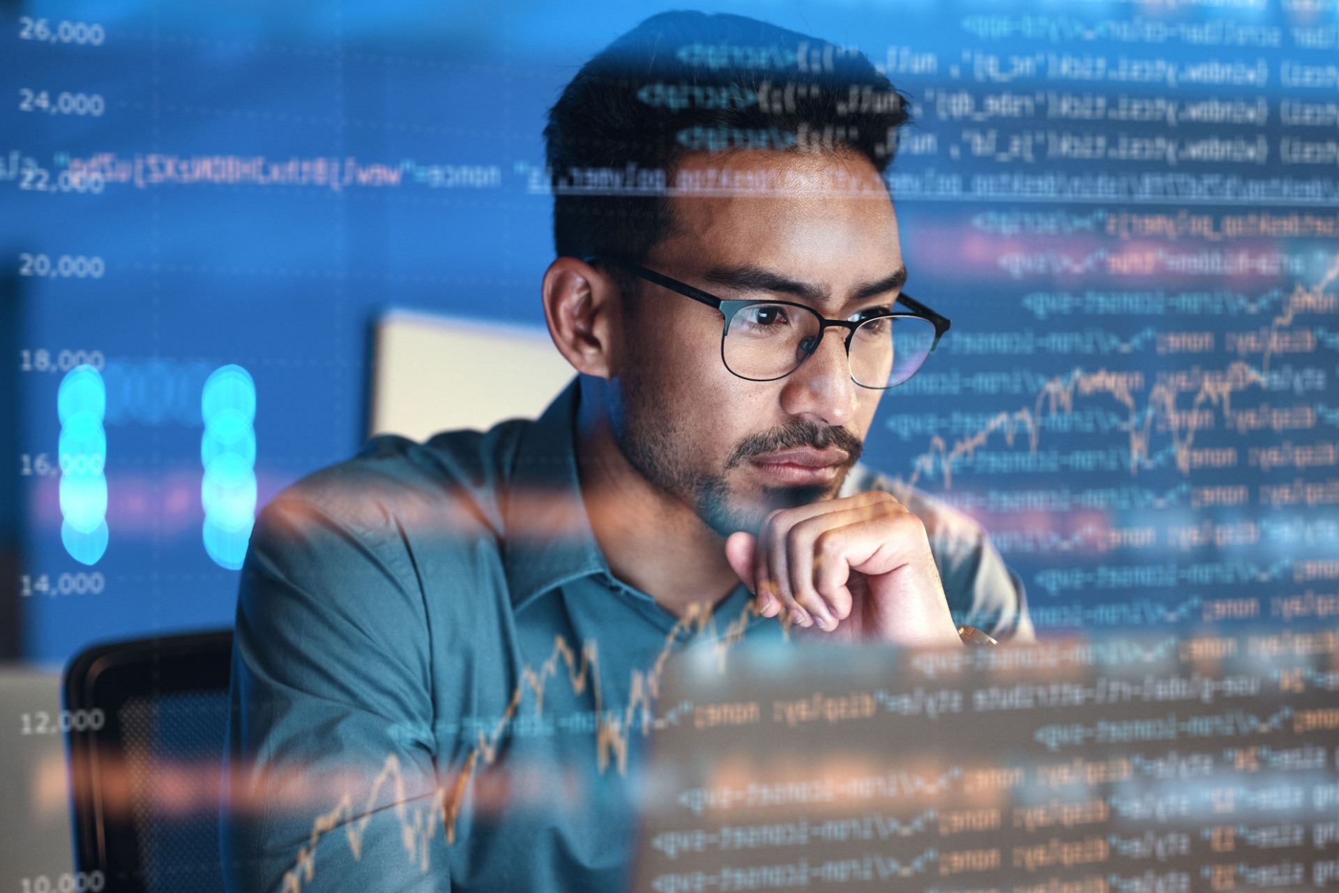 Man looking at a computer screen coding