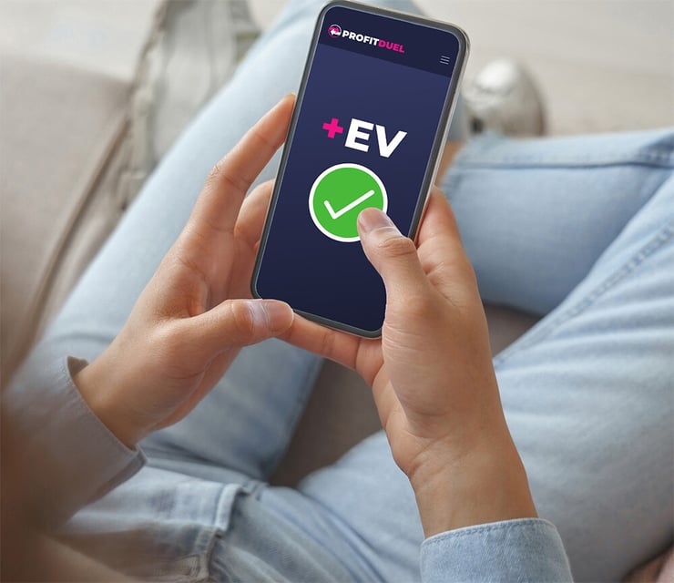 image of somebody holding a mobile phone that has +ev and a green tick on the screen.
