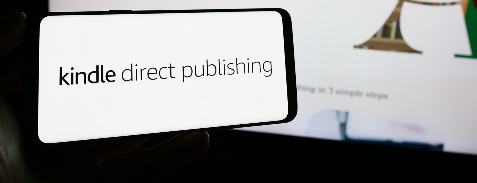 A phone that says Kindle direct publishing on the screen. 