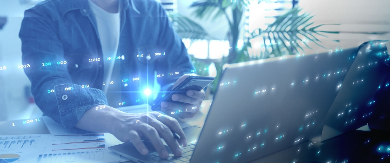 Person using laptop with blue hue