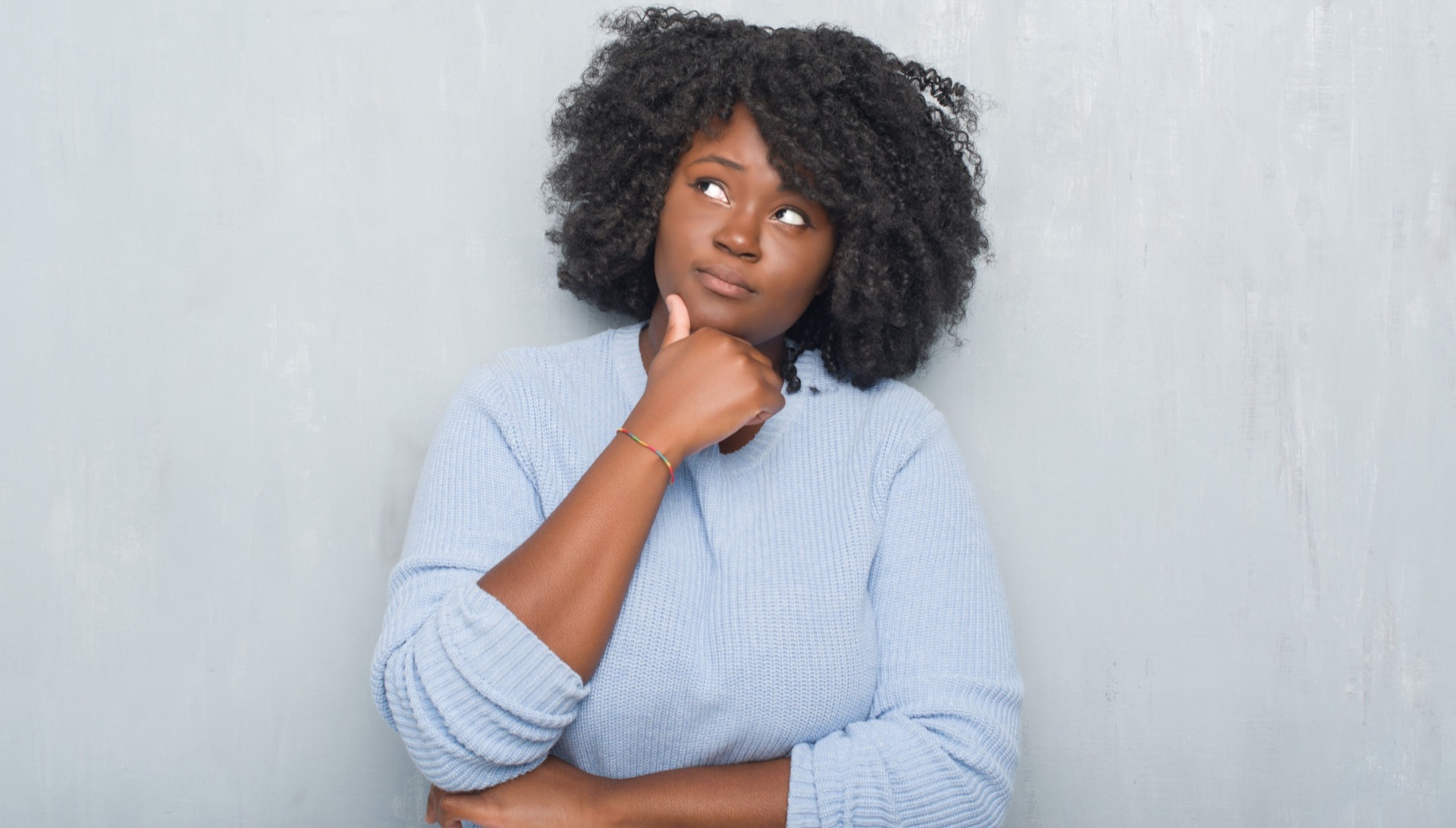 African American woman thinking and looking upwards