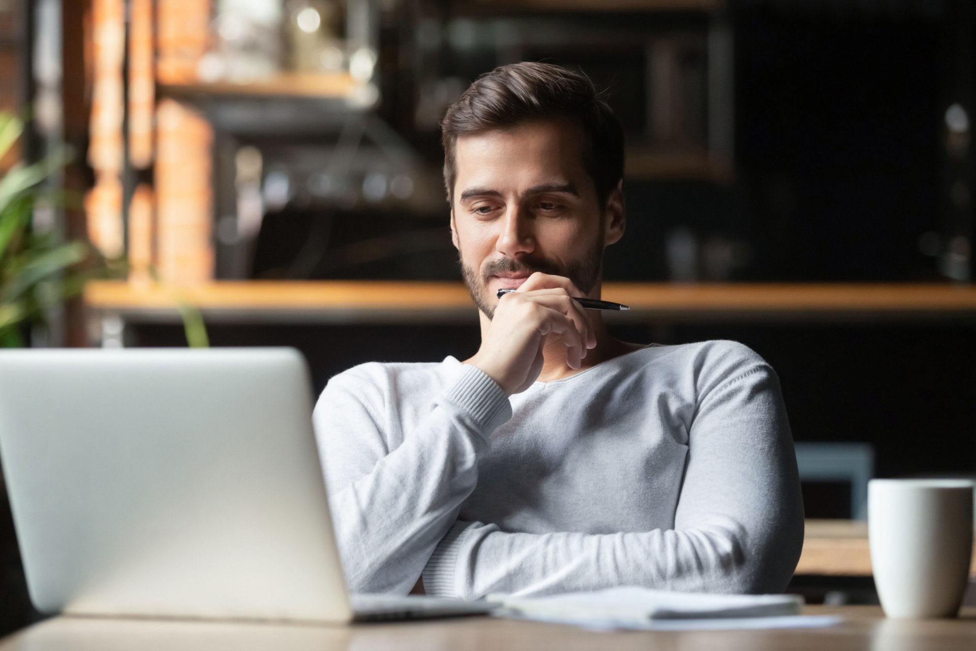 Freelance writer staring at his computer screen.