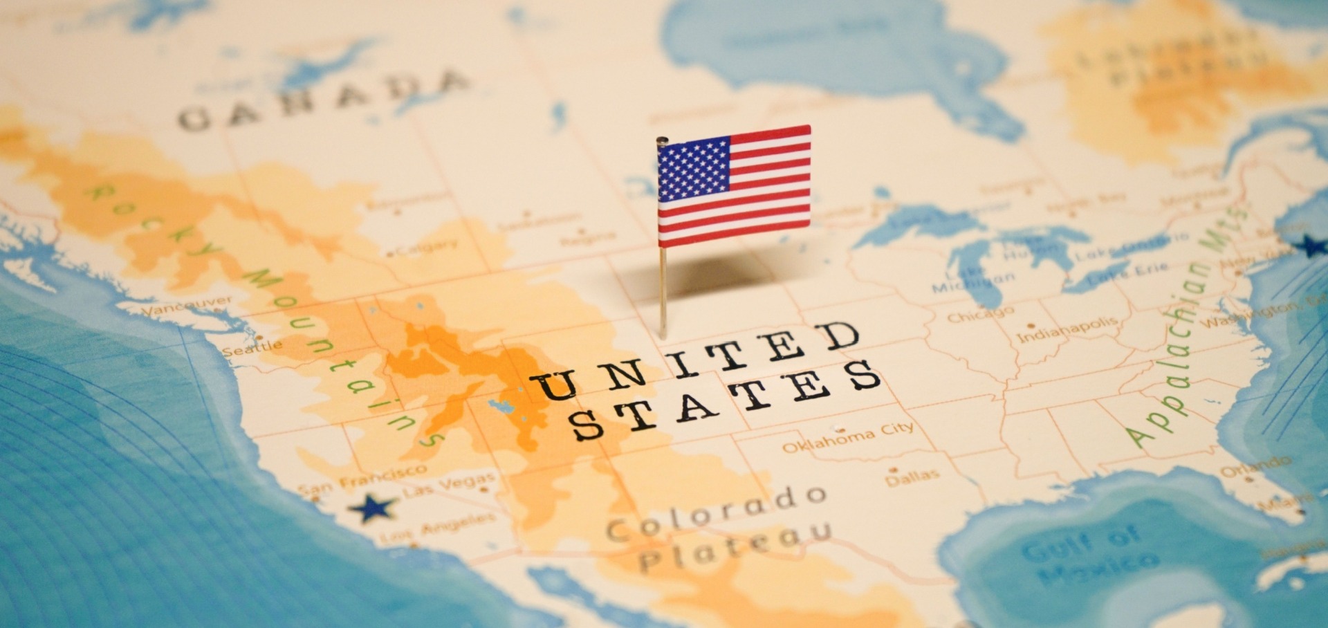 US map with US flag planted in the centre