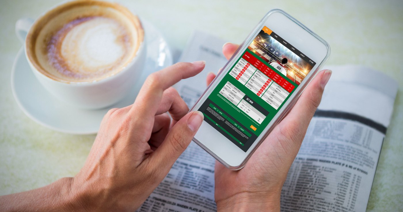 Person signing up to a sportsbook on his mobile phone