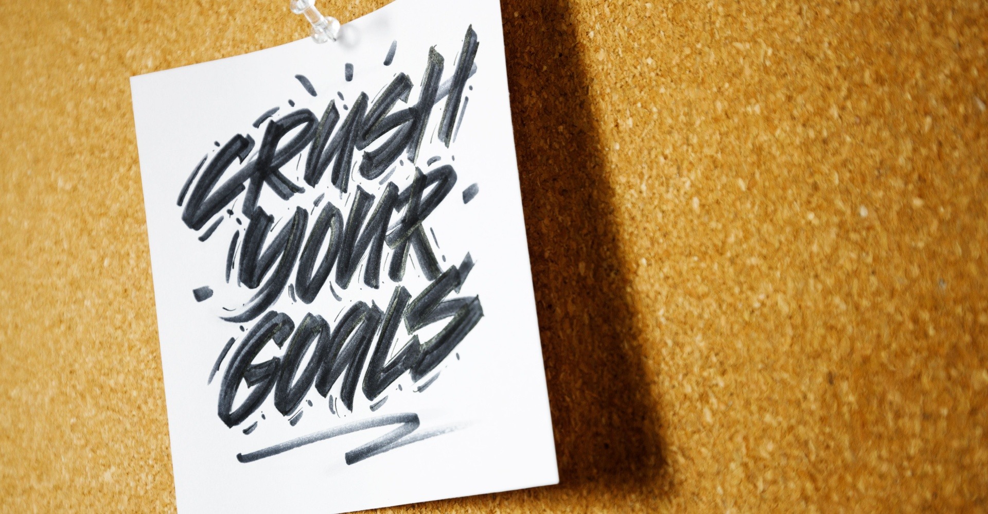 Crush your goals on a piece of paper stuck into a wooden board