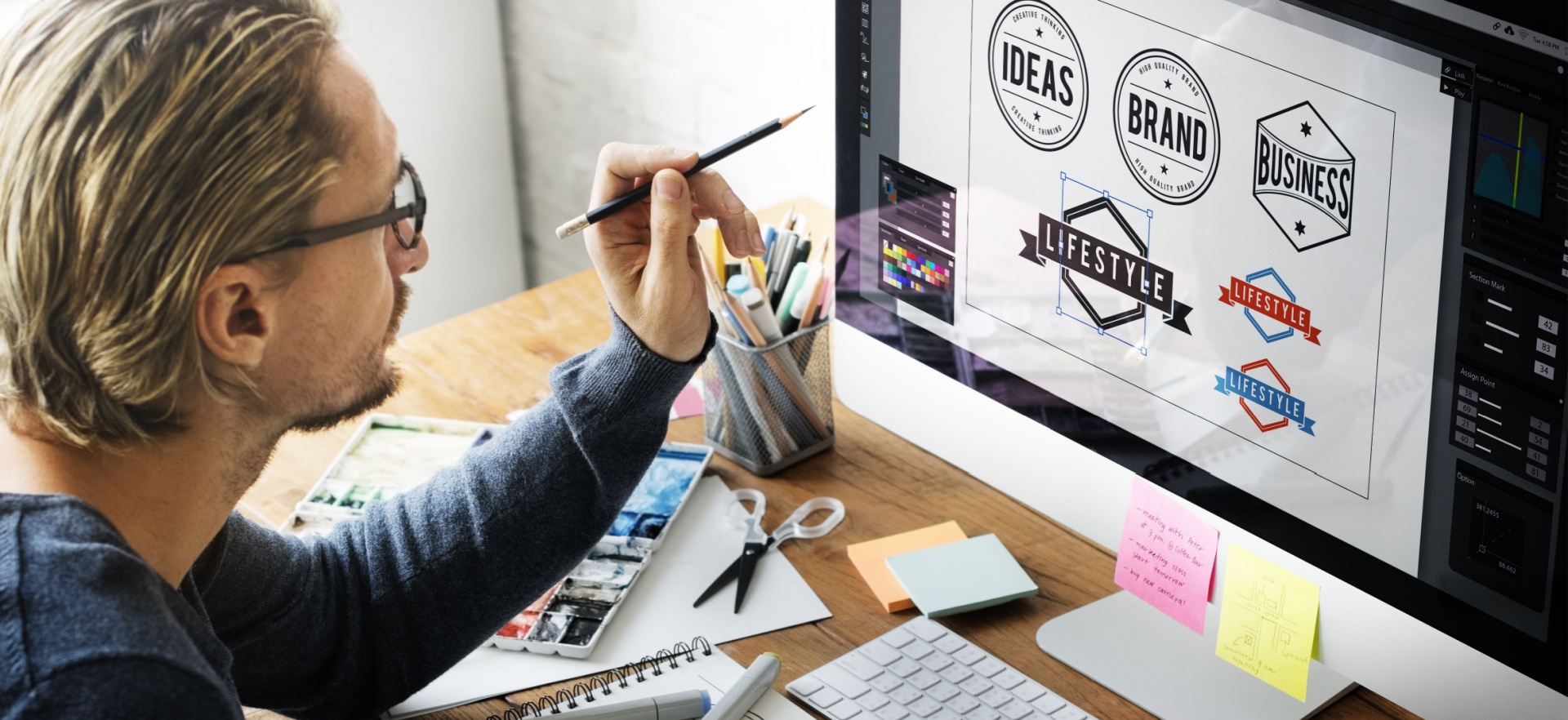 guy designing a logo using a electronic pencil.
