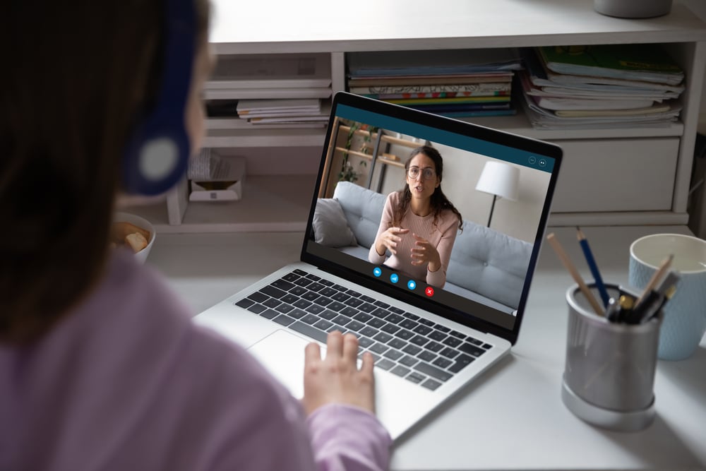Online tutor giving lecture to college student