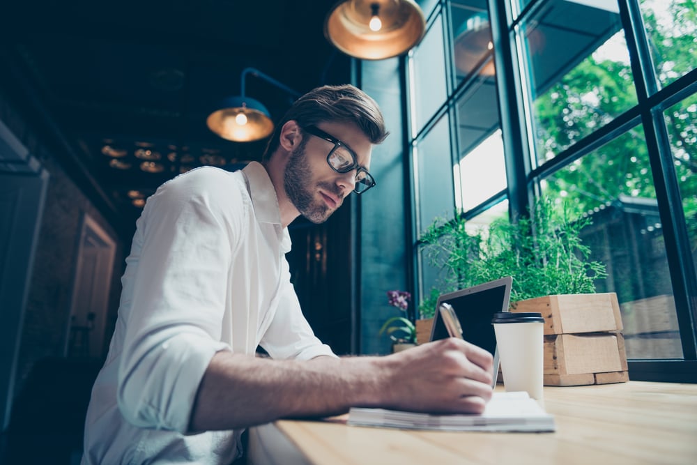 Freelance writer college student writing on notepad