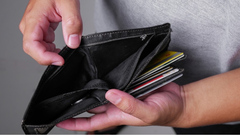 close up hands holding empty wallet