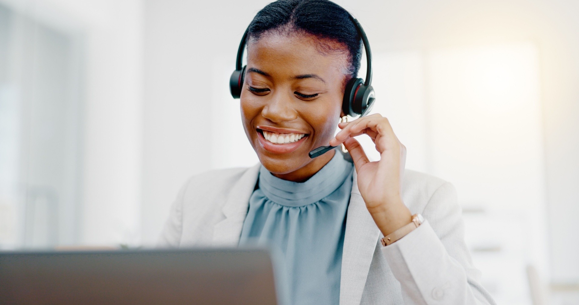 woman answering the phone at a call center. Smiling and looking friendly
